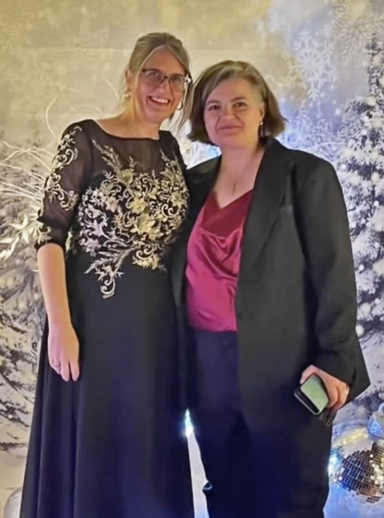 Photo of two women in fancy dress amidst a wintery scene