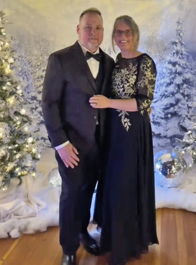 Photo of a couple in fancy dress amidst a wintery scene