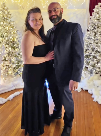 Photo of a couple in fancy dress amidst a wintery scene