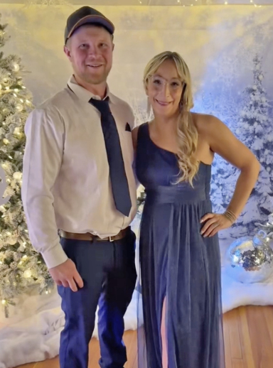 Photo of a couple in fancy dress amidst a wintery scene
