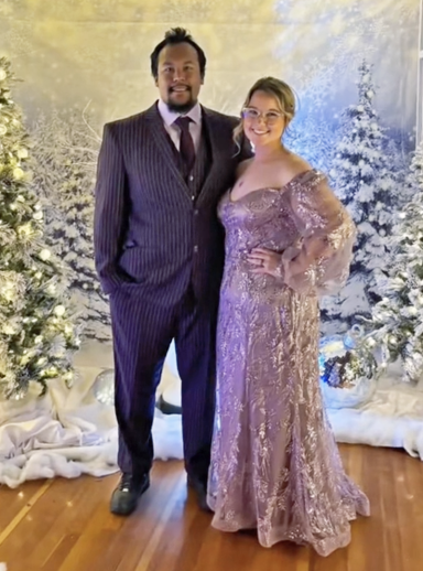 Photo of a couple in fancy dress amidst a wintery scene