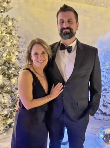 Photo of a couple in fancy dress amidst a wintery scene