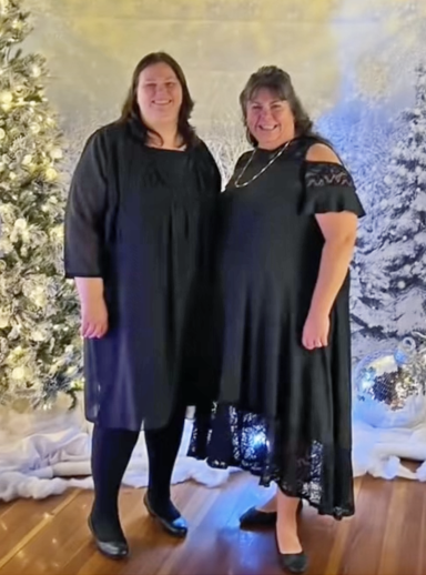 Photo of two women in fancy dress amidst a wintery scene