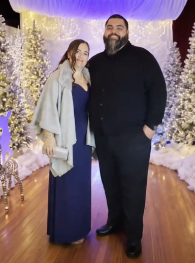 Photo of a couple in fancy dress amidst a wintery scene