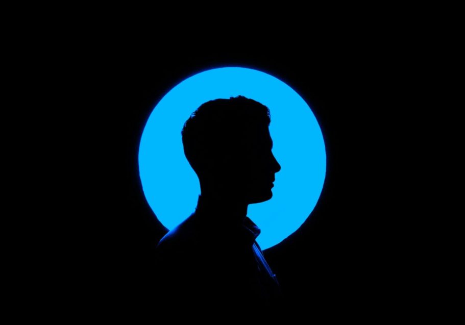 Dark silhouette against a blue circle