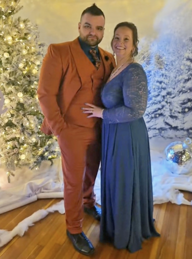 Photo of a couple in fancy dress amidst a wintery scene